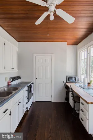 a kitchen with sink cabinets and wooden floor