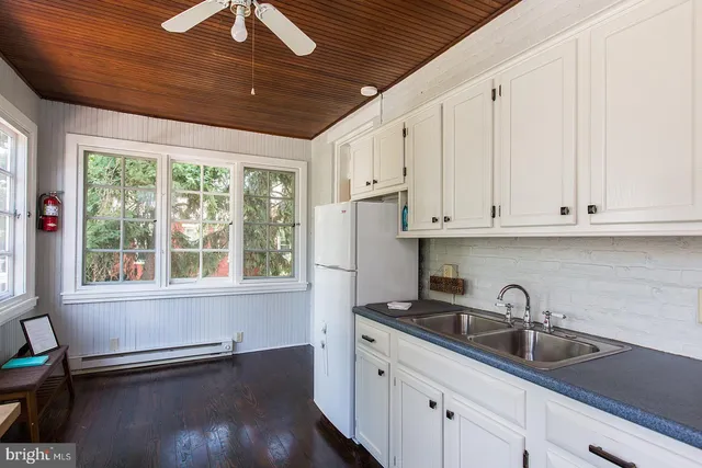 a kitchen with granite countertop a sink stainless steel appliances and cabinets