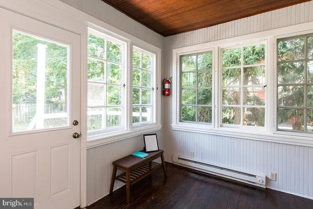 a room with a window and wooden floor