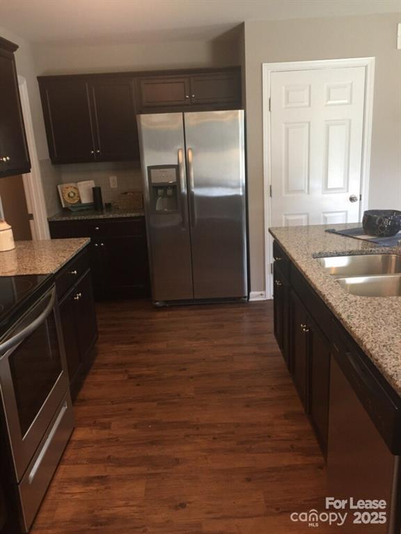 4208 Long Arrow Drive Concord, NC 28025 - Photo 4 of 12 a kitchen with kitchen island granite countertop a sink and a refrigerator