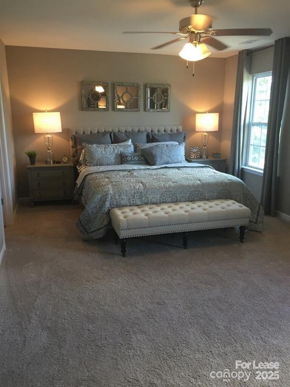 4208 Long Arrow Drive Concord, NC 28025 - Photo 6 of 12 a bedroom with a bed and a chandelier
