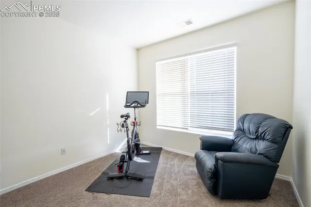 a view of a livingroom with workspace and a window