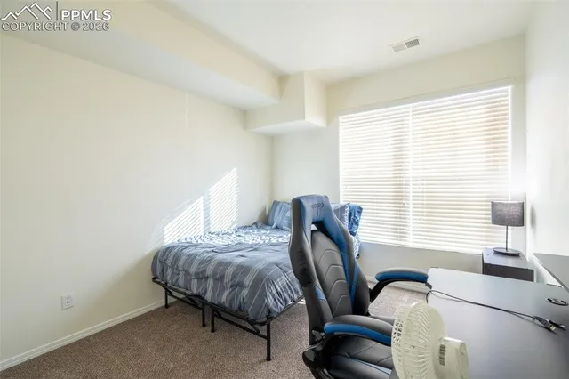 a bedroom with bed and a window