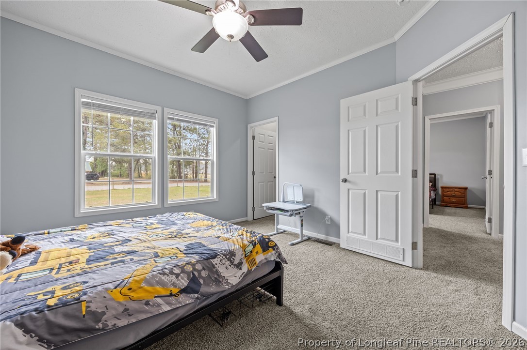 2252 Old Stage Road South Erwin, NC 28339 - Photo 20 of 47 a bedroom with a bed and a chandelier