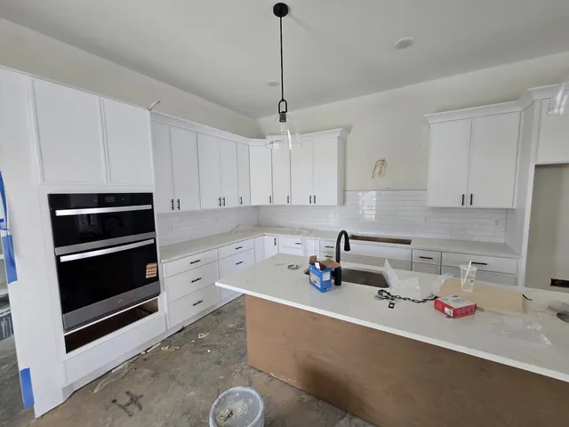 a kitchen with sink and cabinets