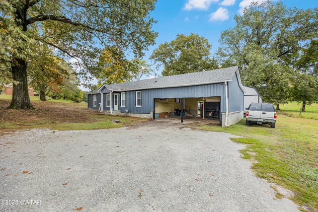 a view of house with outdoor space and swimming pool
