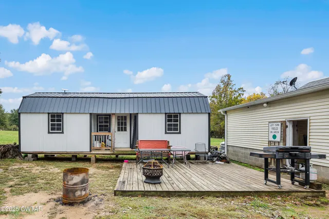 a view of a house with swimming pool and sitting area