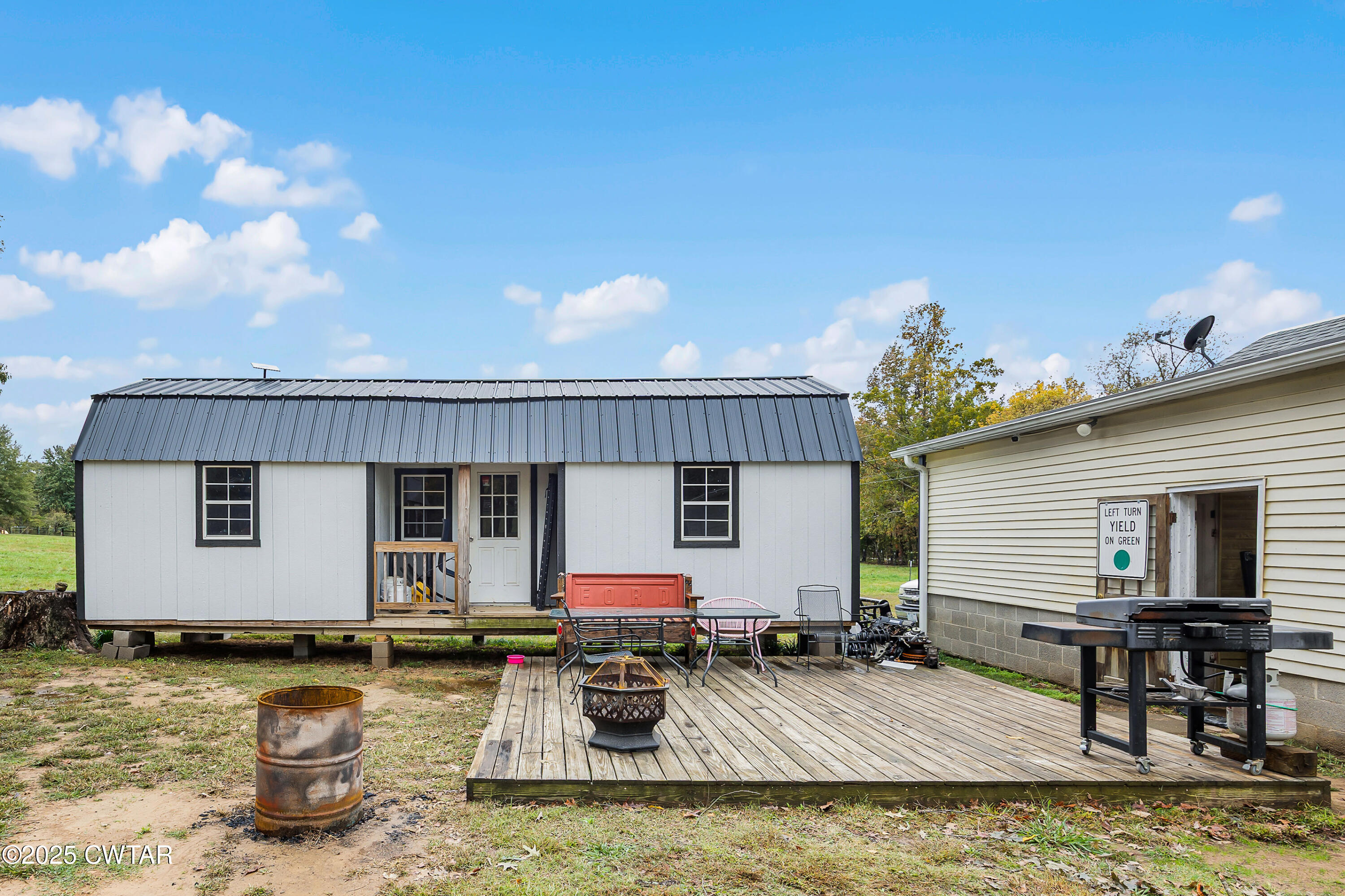 208 Germantown Road Milan, TN 38358 - Photo 15 of 16 a view of a house with swimming pool and sitting area