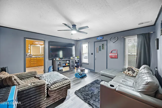 a bedroom with two beds and a large window