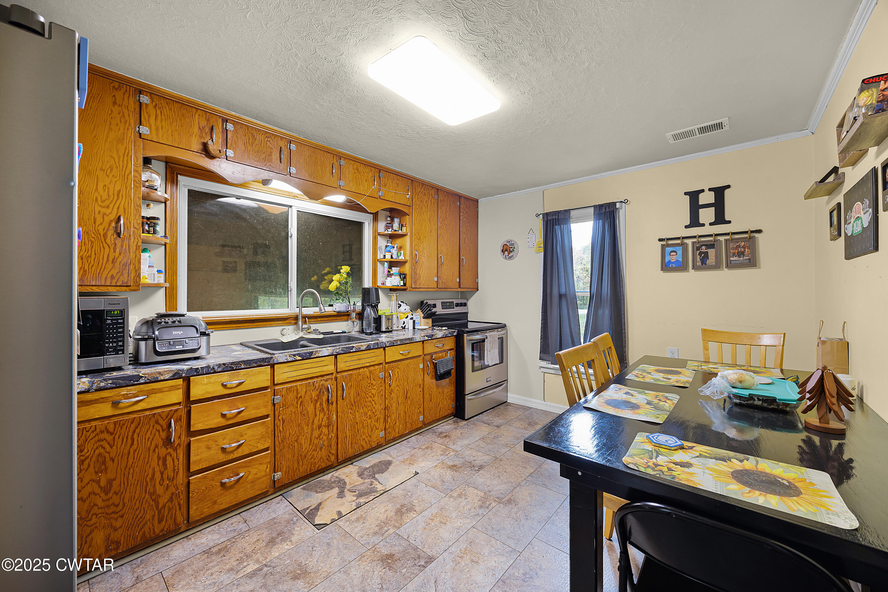 208 Germantown Road Milan, TN 38358 - Photo 5 of 16 a view of a kitchen area with furniture and window