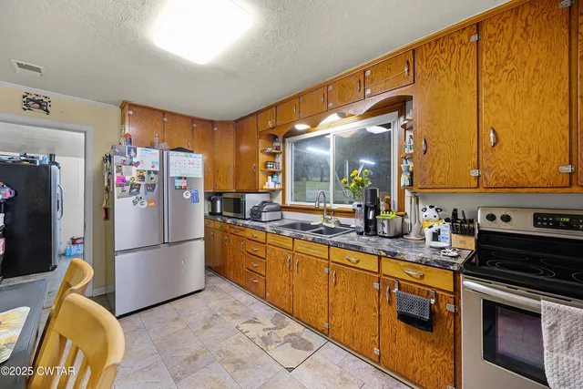 a kitchen with refrigerator and cabinets
