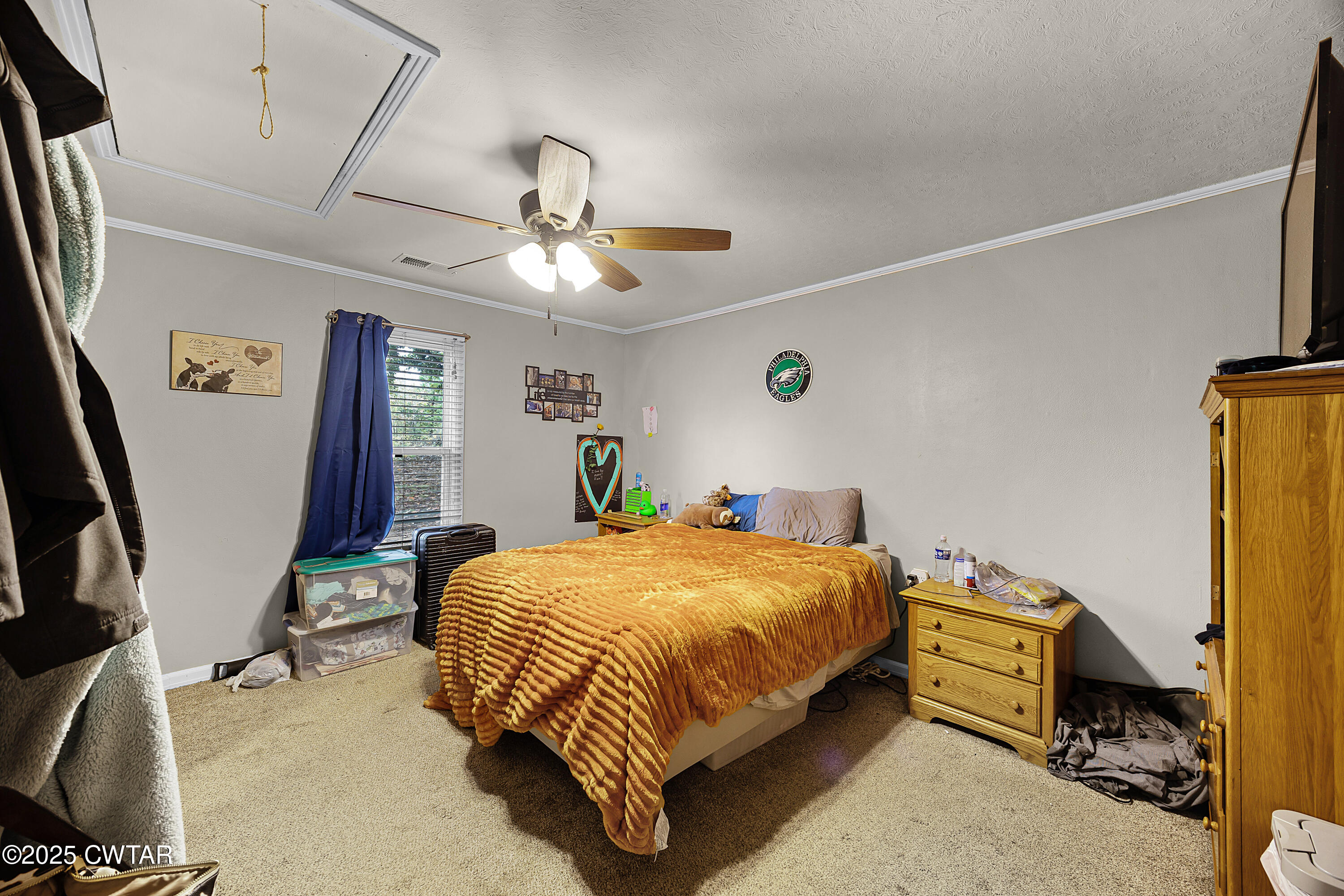 208 Germantown Road Milan, TN 38358 - Photo 8 of 16 a bedroom with a bed and a chandelier