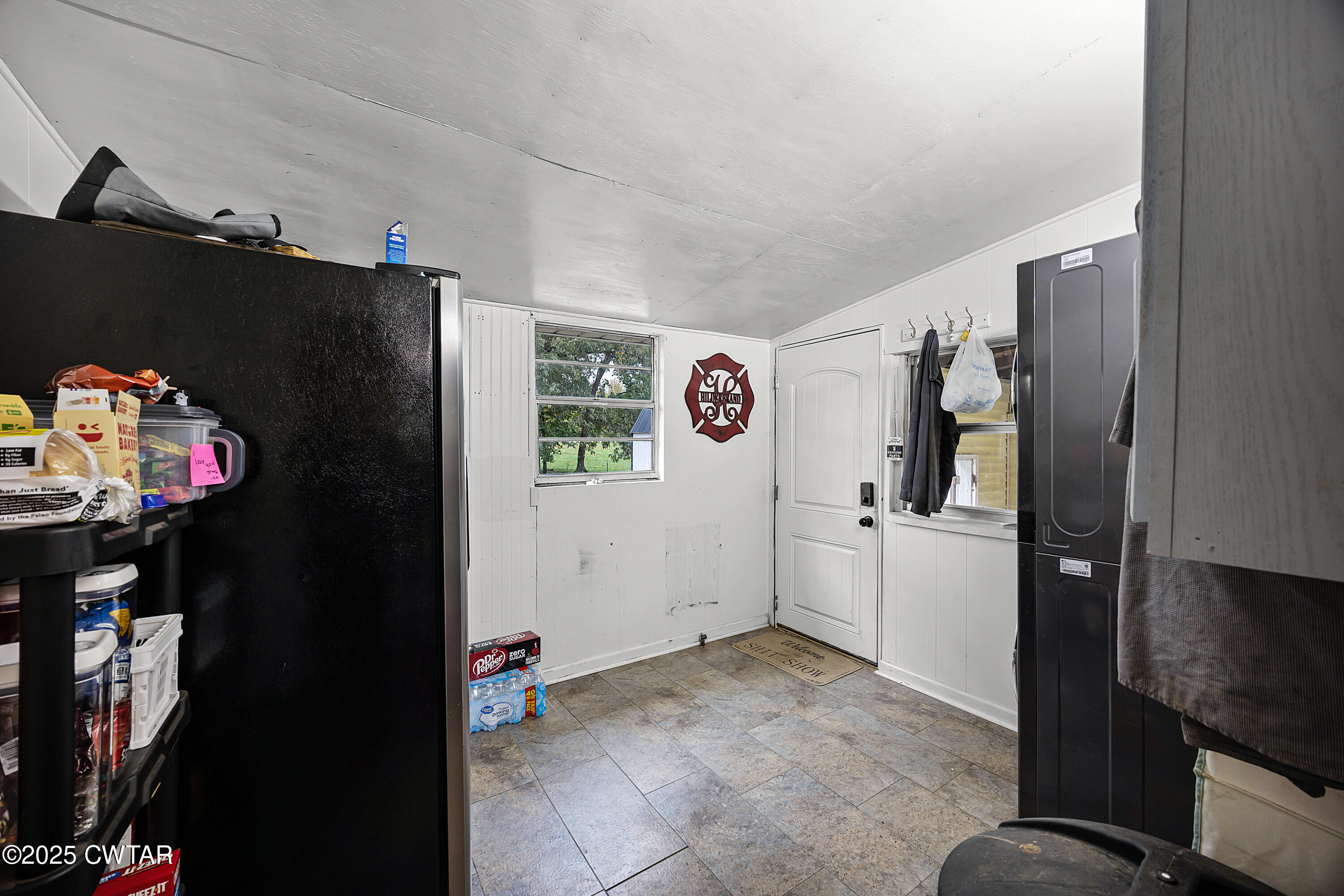 208 Germantown Road Milan, TN 38358 - Photo 10 of 16 a view of a kitchen with fridge and workspace