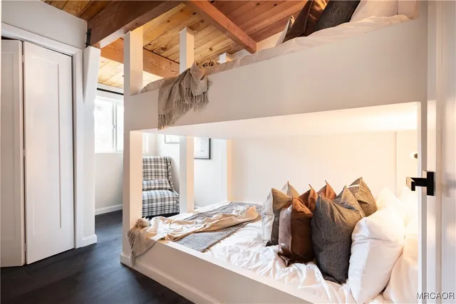 a bathroom with a shower a sink a toilet and mirror