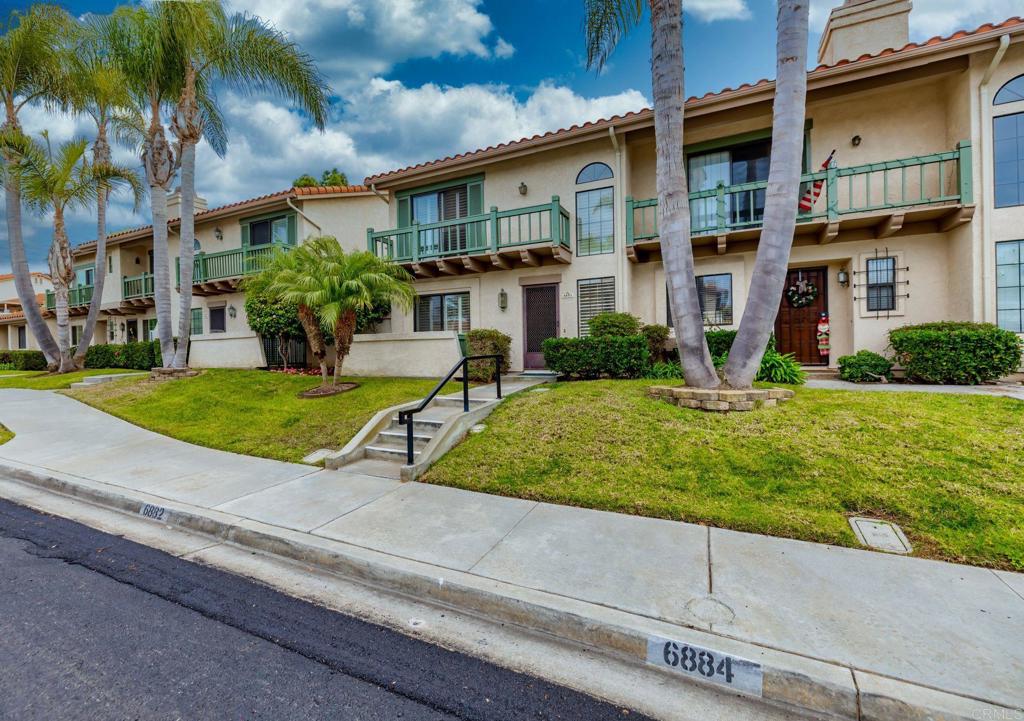 6882 Batiquitos Drive Carlsbad, CA 92011 - Photo 1 of 47 a view of a brick house with a yard plants and palm trees