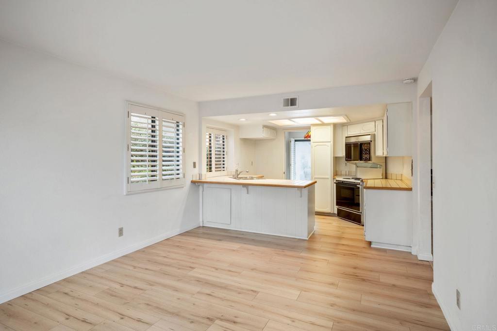 6882 Batiquitos Drive Carlsbad, CA 92011 - Photo 15 of 47 a large white kitchen with granite countertop a large counter top and sink