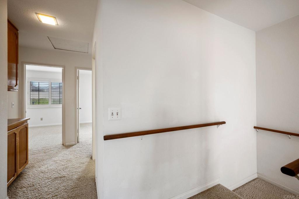 6882 Batiquitos Drive Carlsbad, CA 92011 - Photo 17 of 47 a view of a hallway with wooden floor