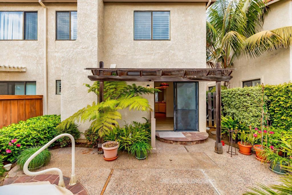 6882 Batiquitos Drive Carlsbad, CA 92011 - Photo 28 of 47 front view of a house with potted plants and a bench