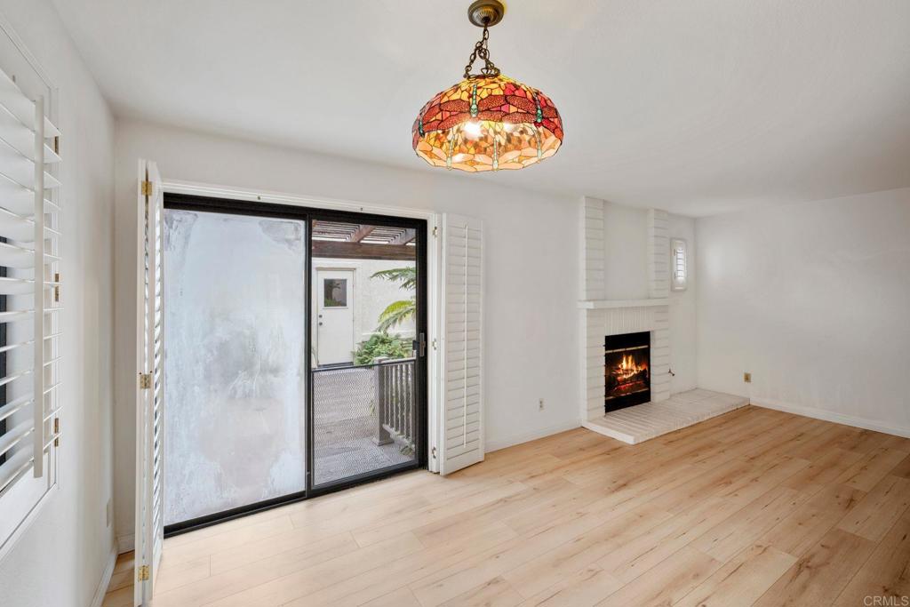 6882 Batiquitos Drive Carlsbad, CA 92011 - Photo 8 of 47 a view of an empty room with a fireplace and a window