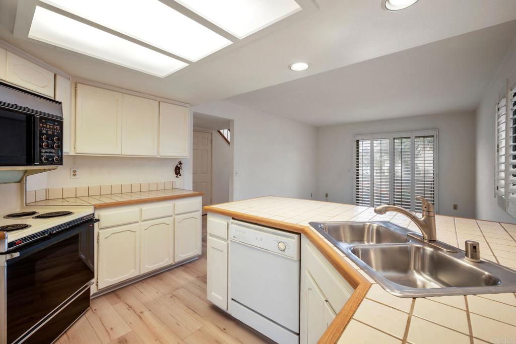 6882 Batiquitos Drive Carlsbad, CA 92011 - Photo 10 of 47 a kitchen that has a sink and a stove