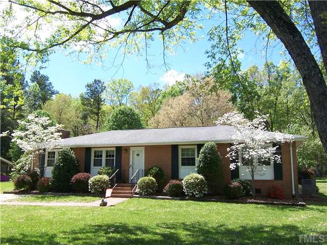 6915 Innesbrook Way Bahama, NC 27503 - Photo 1 of 15 a front view of a house with a garden