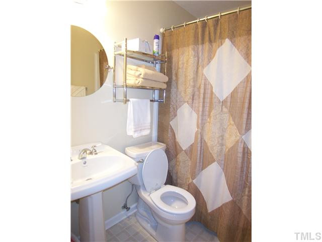 6915 Innesbrook Way Bahama, NC 27503 - Photo 11 of 15 a bathroom with a toilet sink and mirror