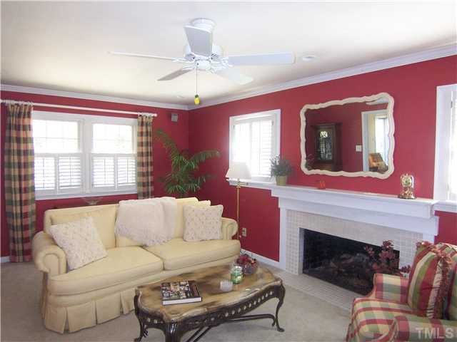 6915 Innesbrook Way Bahama, NC 27503 - Photo 4 of 15 a living room with furniture a fireplace and a large mirror