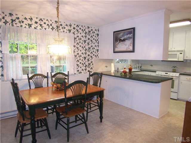 6915 Innesbrook Way Bahama, NC 27503 - Photo 5 of 15 a kitchen with a table chairs and window