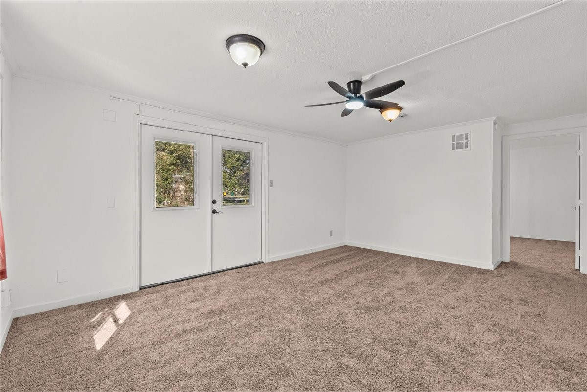 1002 Orange Street La Marque, TX 77568 - Photo 16 of 31 an empty room with fan and a ceiling fan