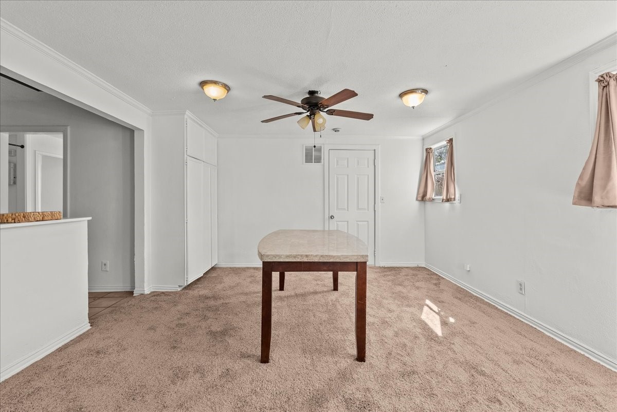 1002 Orange Street La Marque, TX 77568 - Photo 17 of 31 a view of workspace with furniture and a chandelier fan