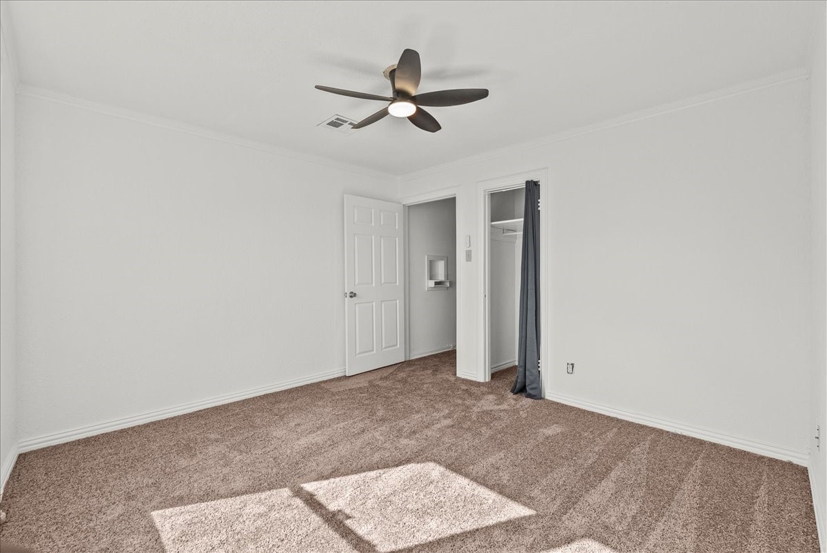 1002 Orange Street La Marque, TX 77568 - Photo 23 of 31 an empty room with ceiling fan and window