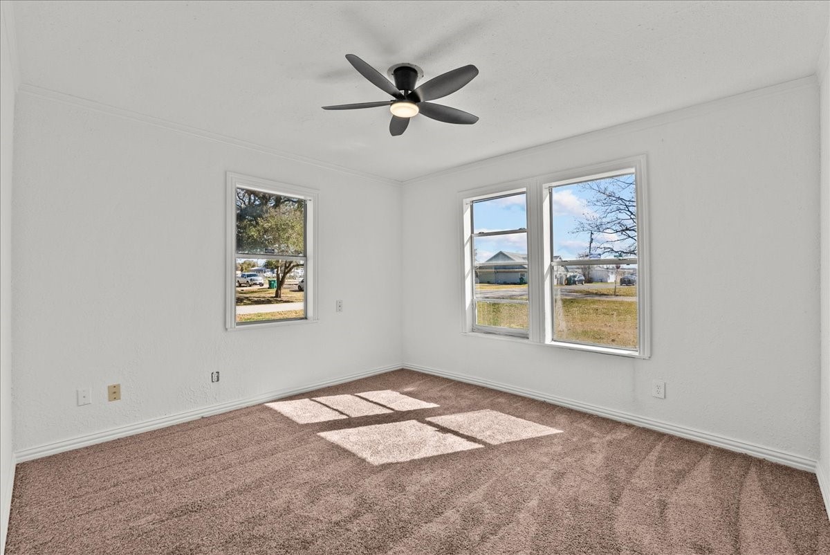 1002 Orange Street La Marque, TX 77568 - Photo 24 of 31 a view of a livingroom with a window and a ceiling fan