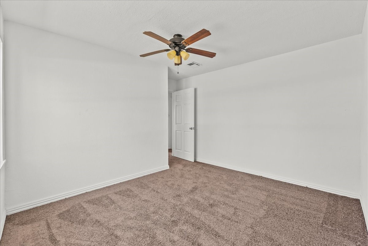 1002 Orange Street La Marque, TX 77568 - Photo 25 of 31 a view of a room with a ceiling fan and a ceiling fan