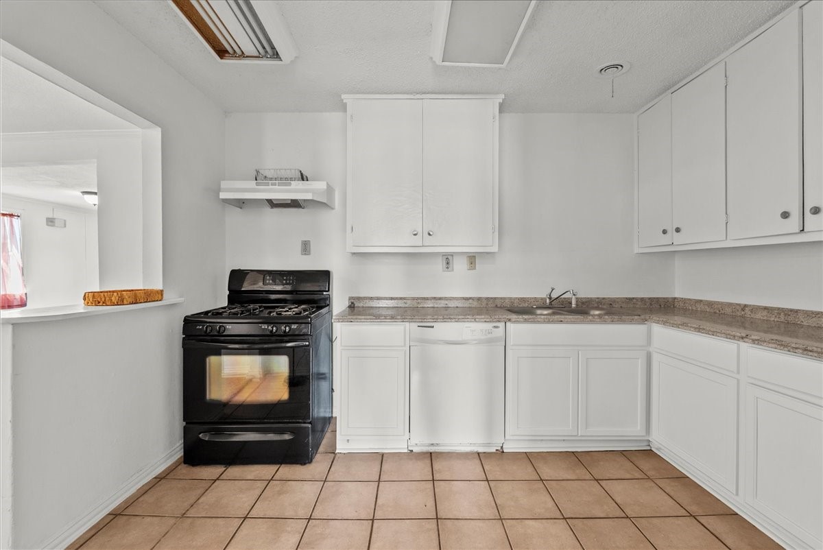 1002 Orange Street La Marque, TX 77568 - Photo 3 of 31 a kitchen with stainless steel appliances granite countertop a stove a sink and a white cabinets