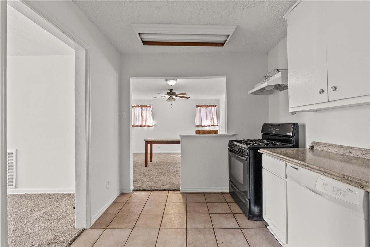 1002 Orange Street La Marque, TX 77568 - Photo 4 of 31 a kitchen with a stove a sink and a refrigerator