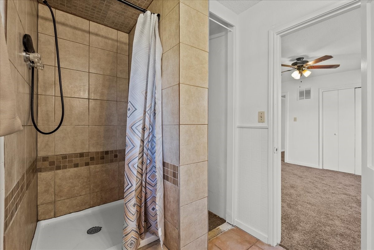1002 Orange Street La Marque, TX 77568 - Photo 6 of 31 a bathroom with a glass shower door