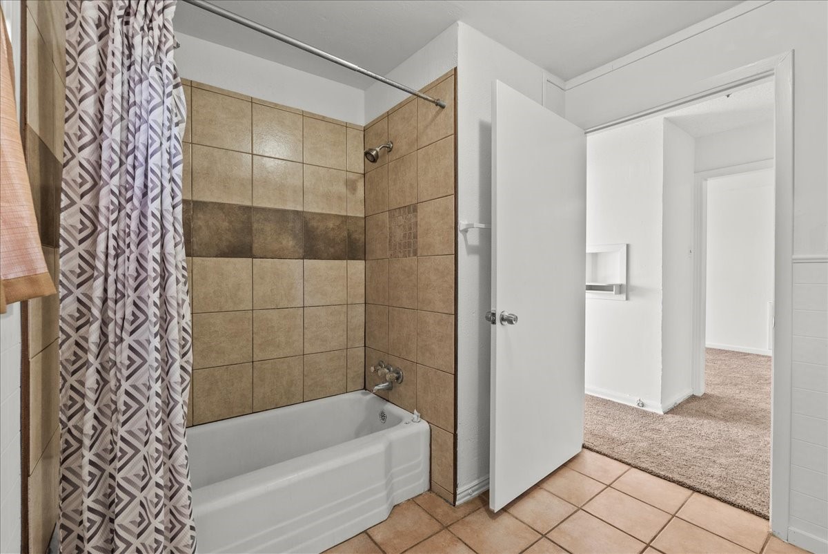 1002 Orange Street La Marque, TX 77568 - Photo 7 of 31 a bathroom with a bathtub and a shower