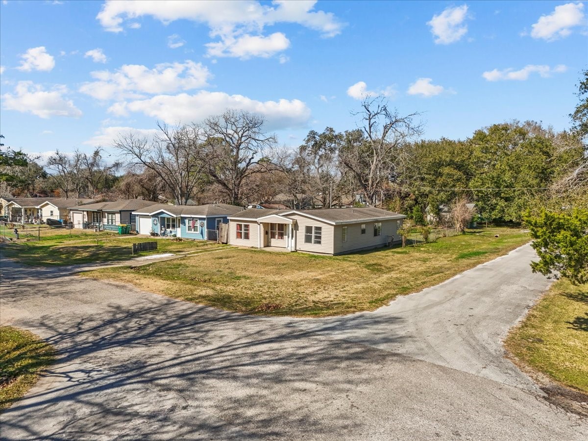 1002 Orange Street La Marque, TX 77568 - Photo 9 of 31 a view of a house with a big yard and large trees