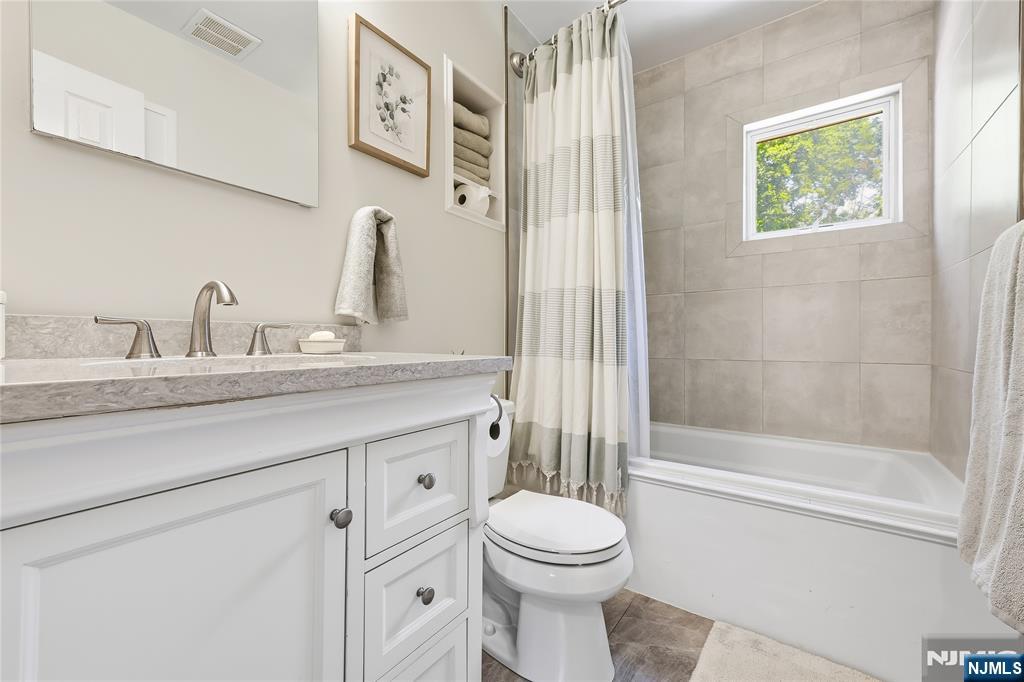 77 White Pond Road Waldwick, NJ 07463 - Photo 16 of 33 a bathroom with a granite countertop sink a toilet and a shower