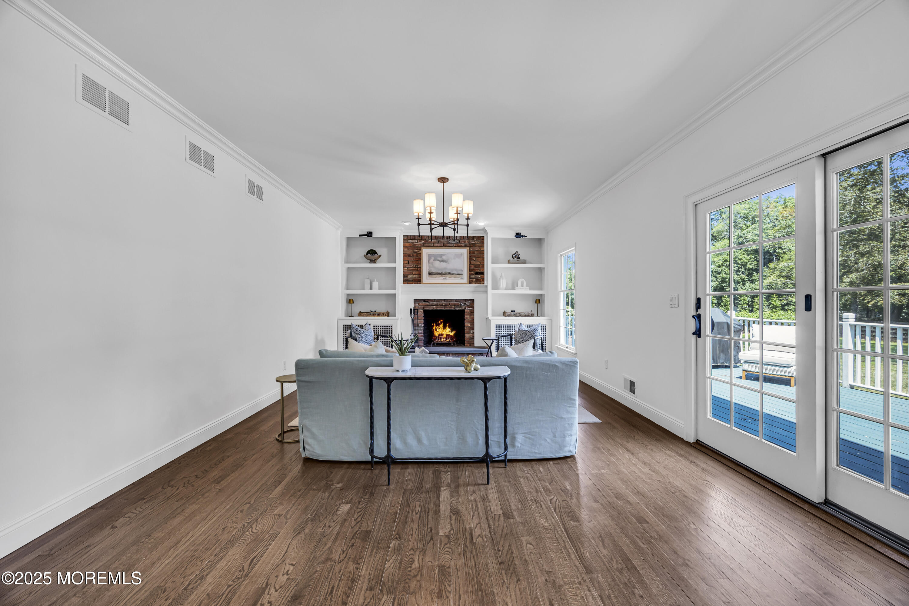 39 Hockhockson Road Colts Neck, NJ 07722 - Photo 33 of 72 a living room with furniture and a fireplace