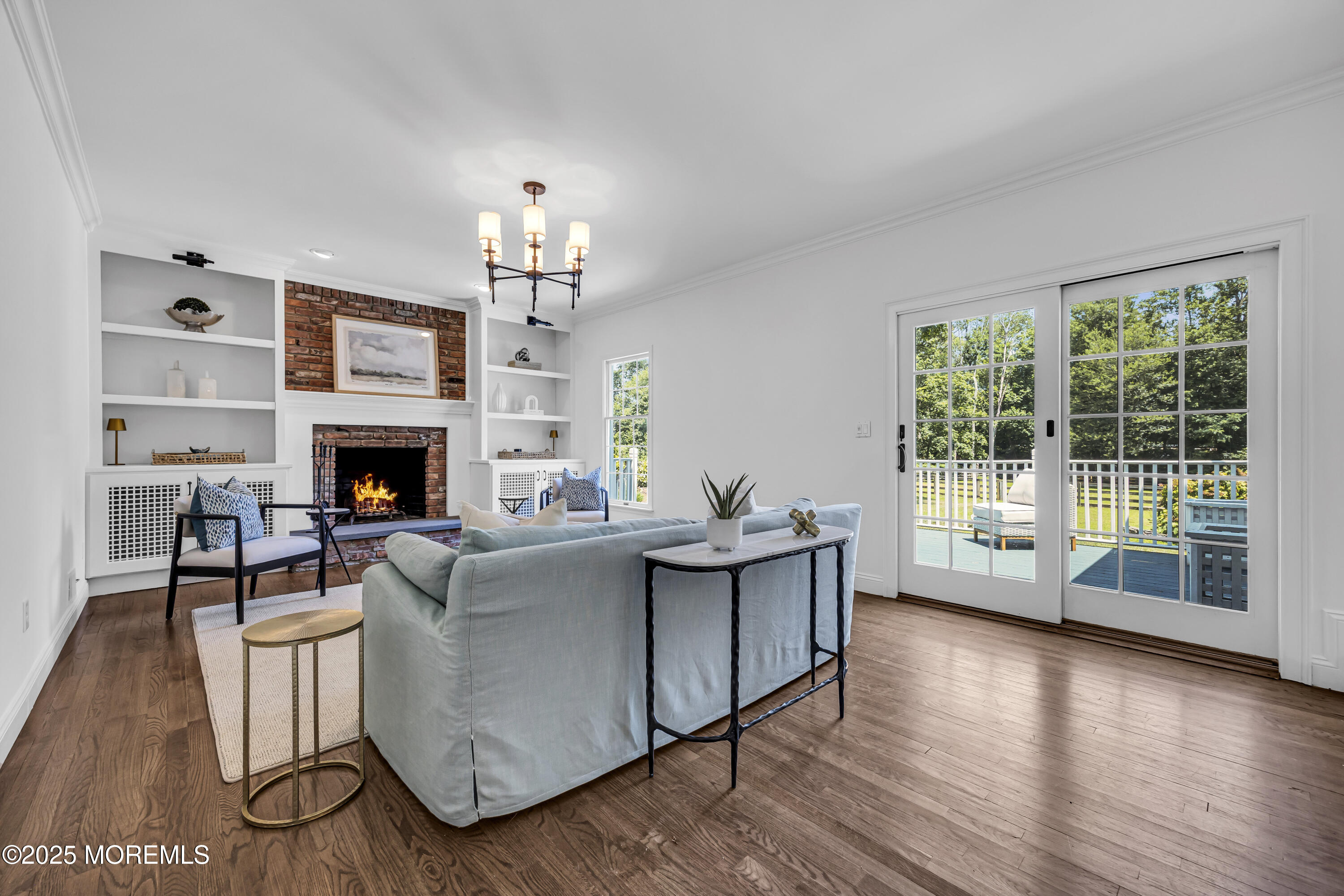 39 Hockhockson Road Colts Neck, NJ 07722 - Photo 34 of 72 a living room with furniture a large window and a fireplace