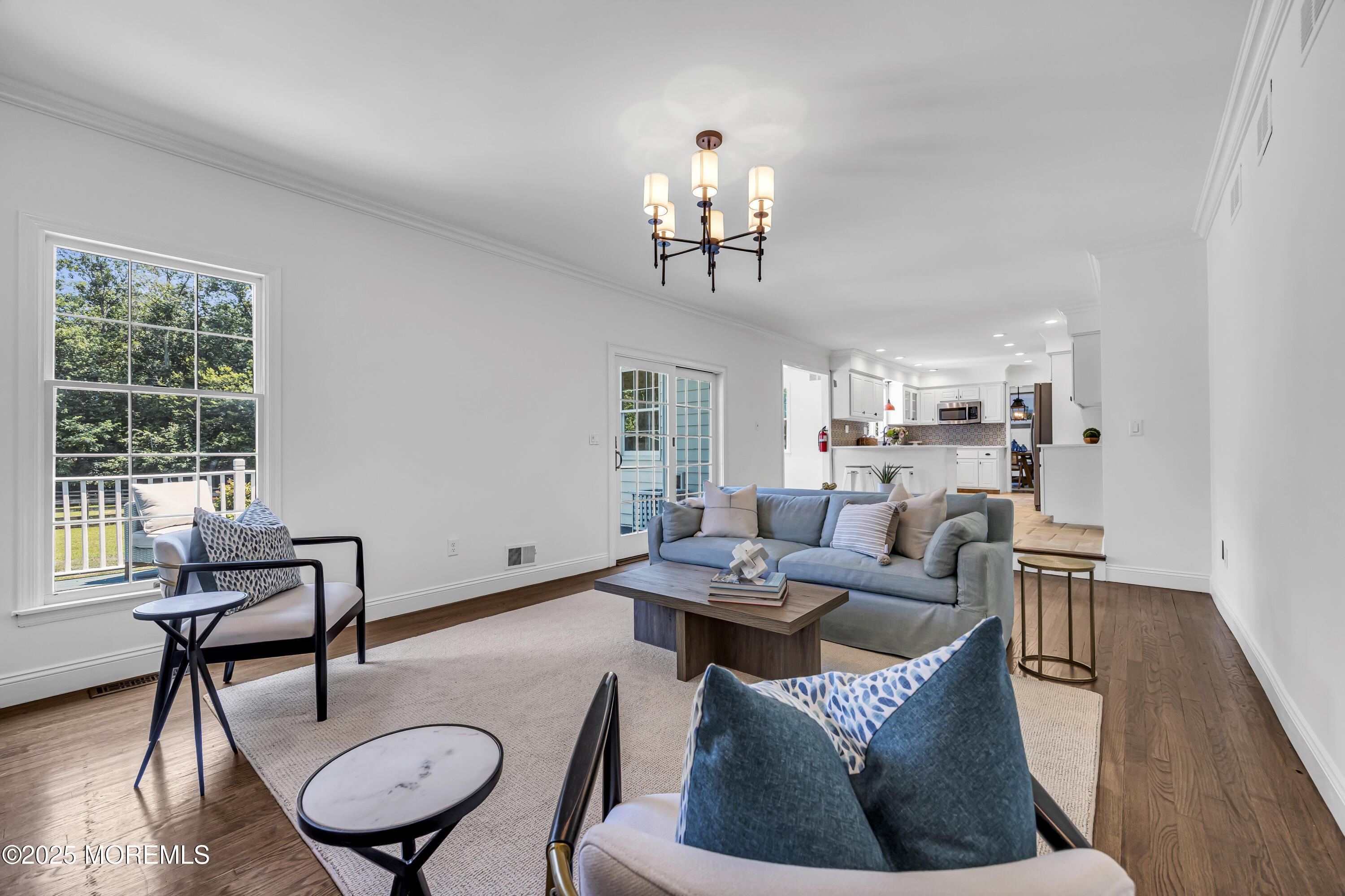 39 Hockhockson Road Colts Neck, NJ 07722 - Photo 36 of 72 a living room with furniture a fireplace and a chandelier