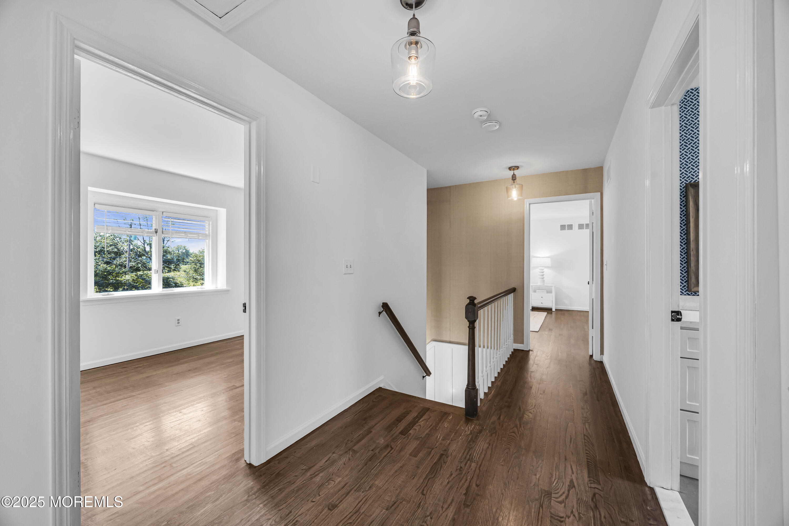 39 Hockhockson Road Colts Neck, NJ 07722 - Photo 37 of 72 a view of a hallway with wooden floor and a bathroom