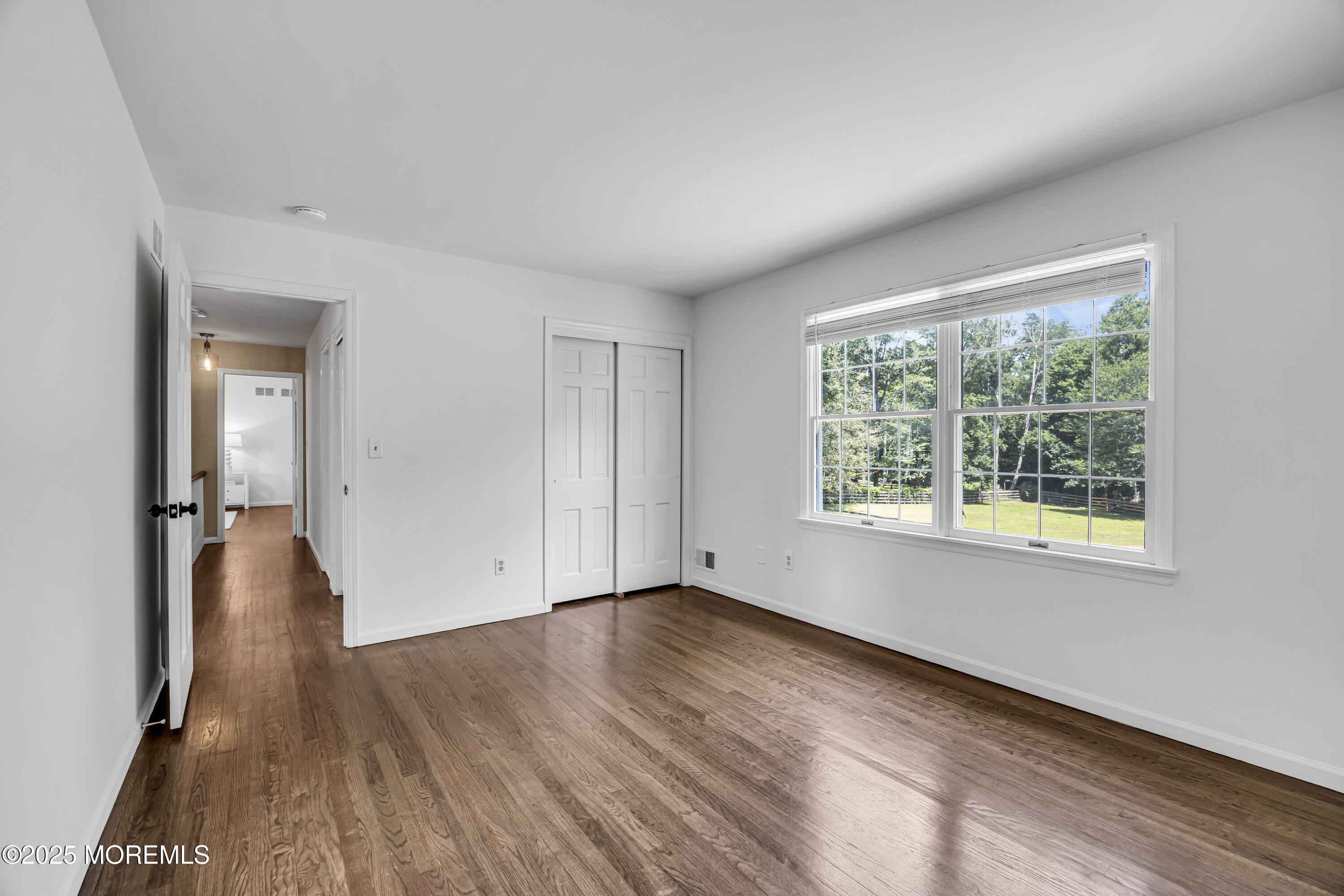 39 Hockhockson Road Colts Neck, NJ 07722 - Photo 40 of 72 a view of wooden floor and windows in a room