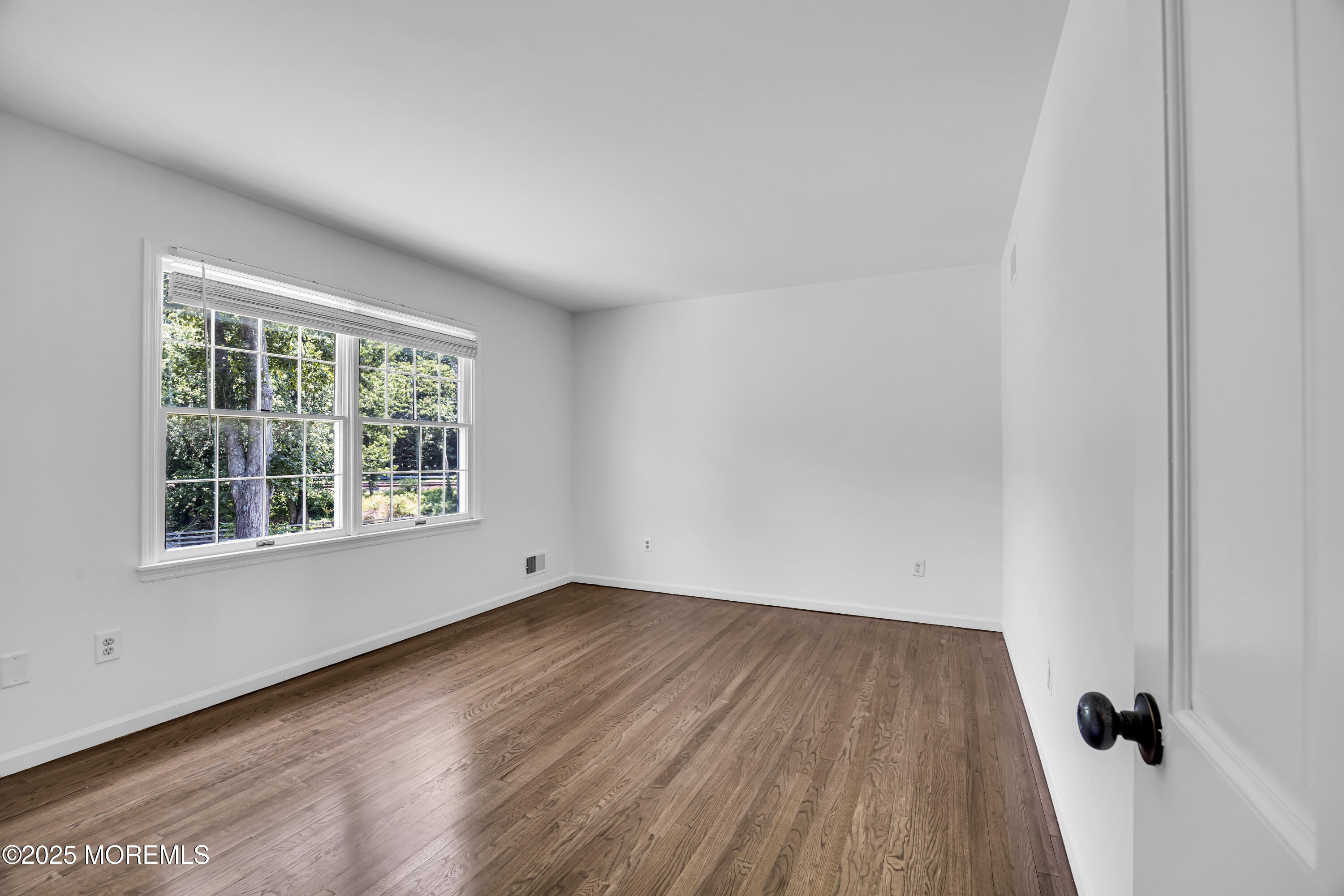 39 Hockhockson Road Colts Neck, NJ 07722 - Photo 41 of 72 an empty room with wooden floor and windows