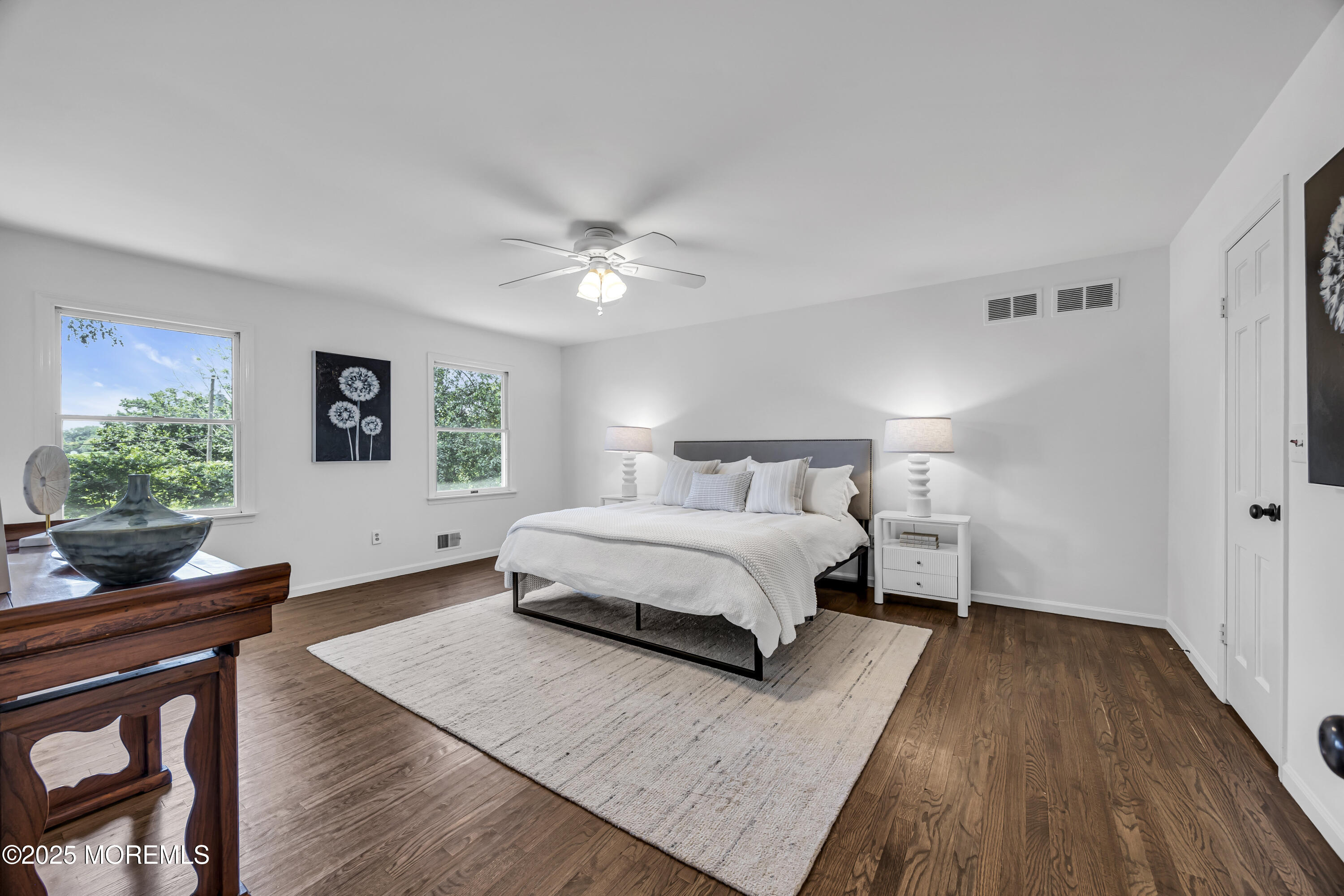 39 Hockhockson Road Colts Neck, NJ 07722 - Photo 45 of 72 a spacious bedroom with a bed and a table in it