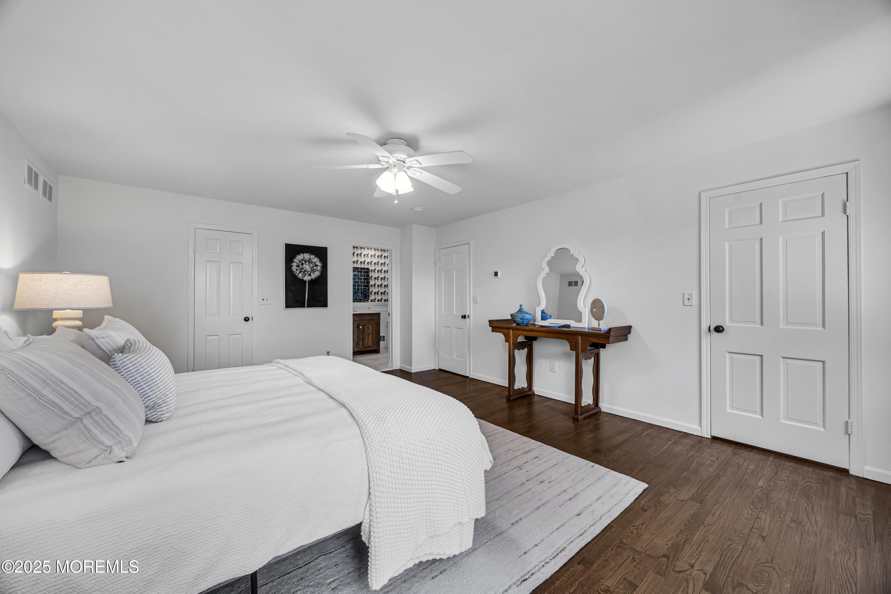 39 Hockhockson Road Colts Neck, NJ 07722 - Photo 46 of 72 a bedroom with a bed and a chandelier