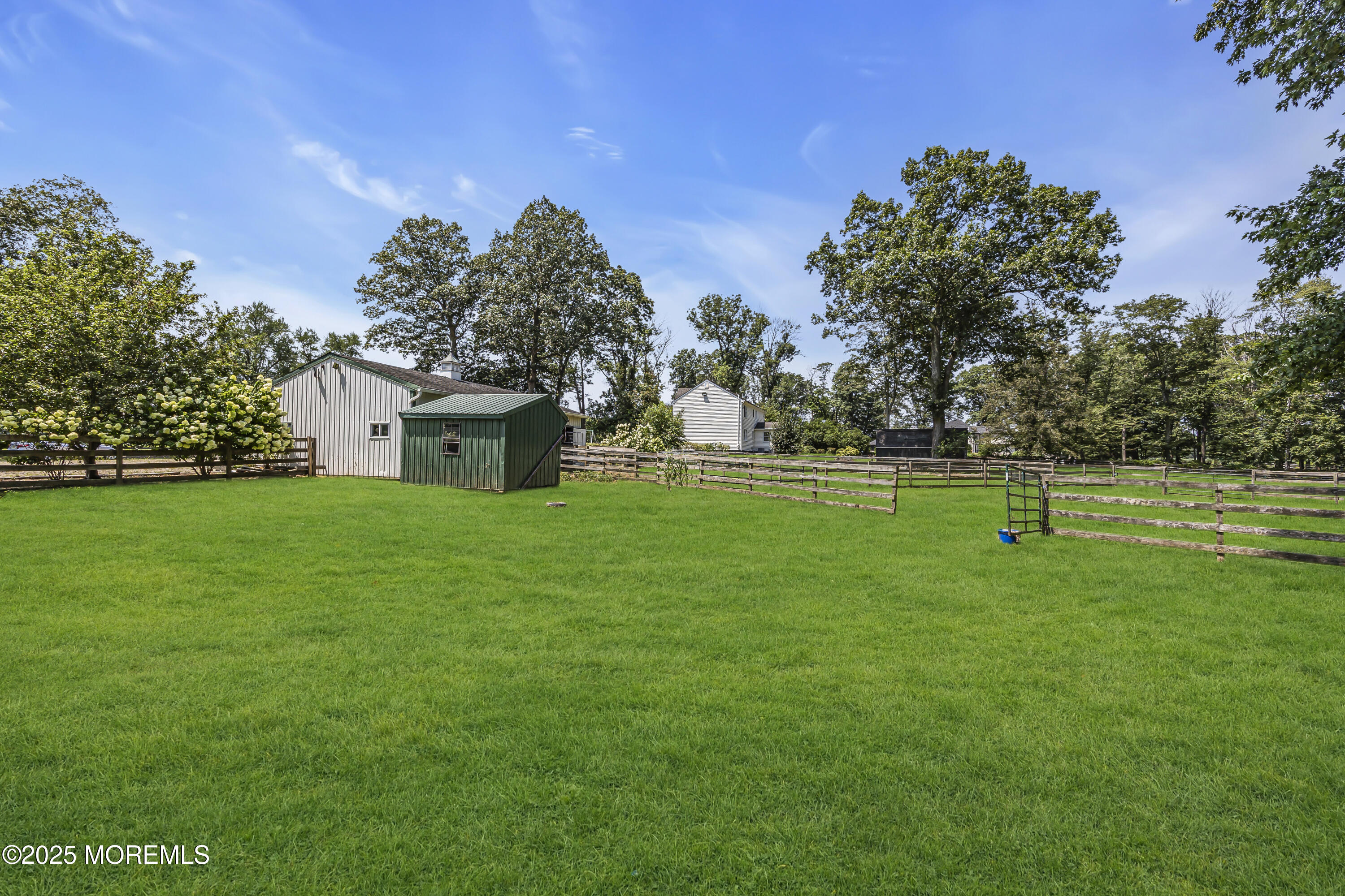 39 Hockhockson Road Colts Neck, NJ 07722 - Photo 64 of 72 a house with green field in front of it