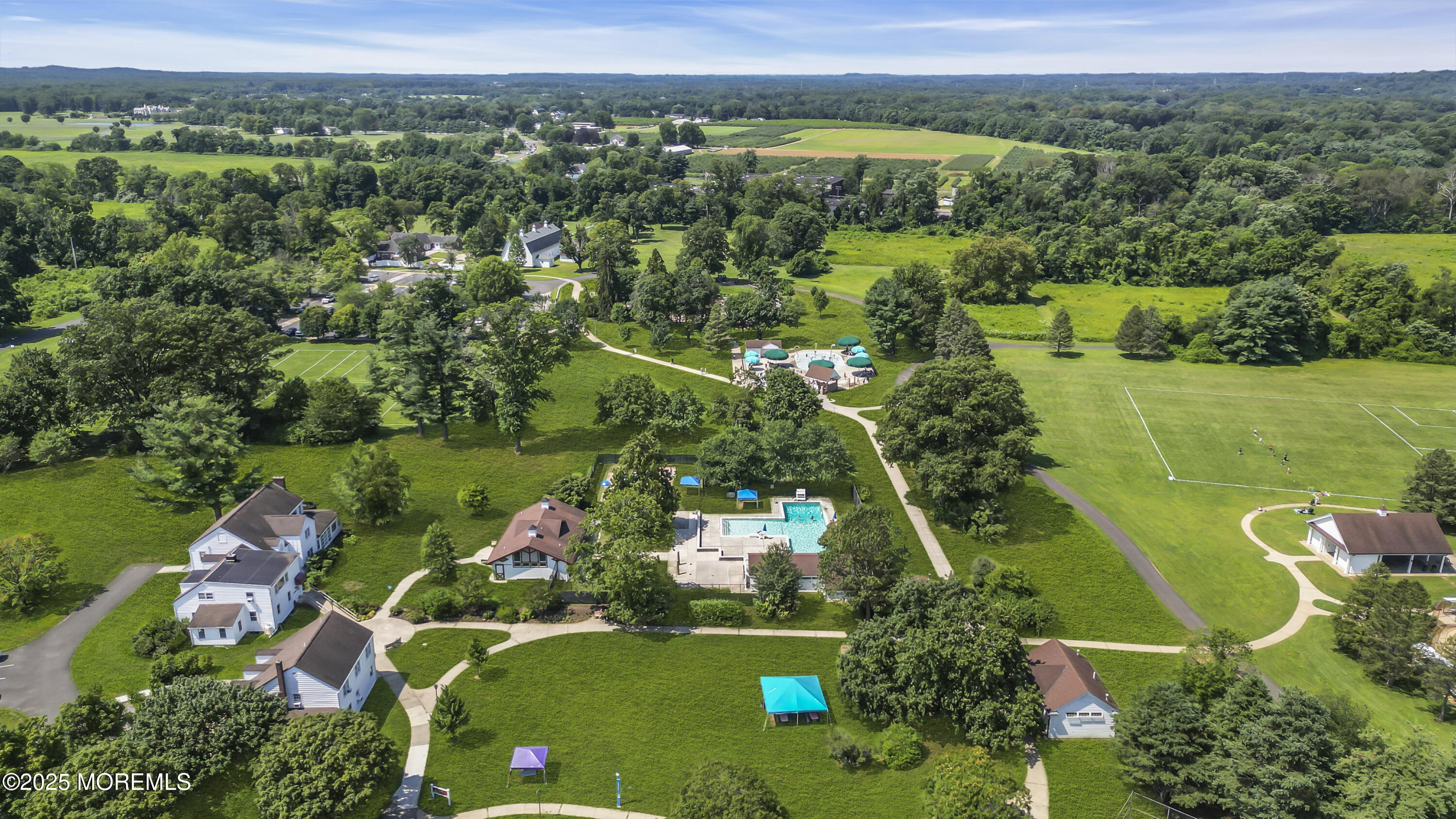 39 Hockhockson Road Colts Neck, NJ 07722 - Photo 7 of 72 an aerial view of lake residential house with swimming pool and green space