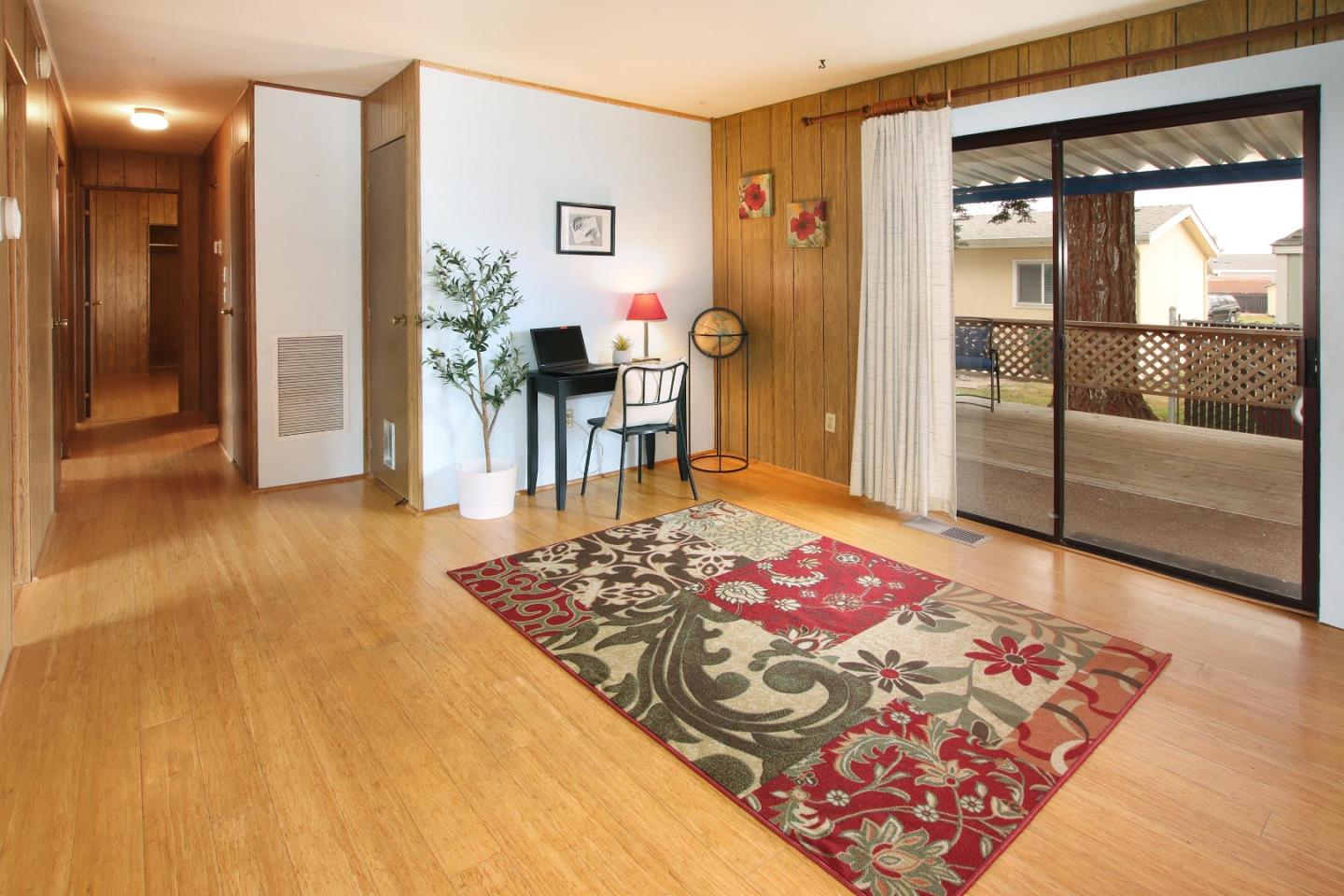 800 Dolan Road, Unit 22 Moss Landing, CA 95039 - Photo 13 of 29 a bedroom with a bed and glass door